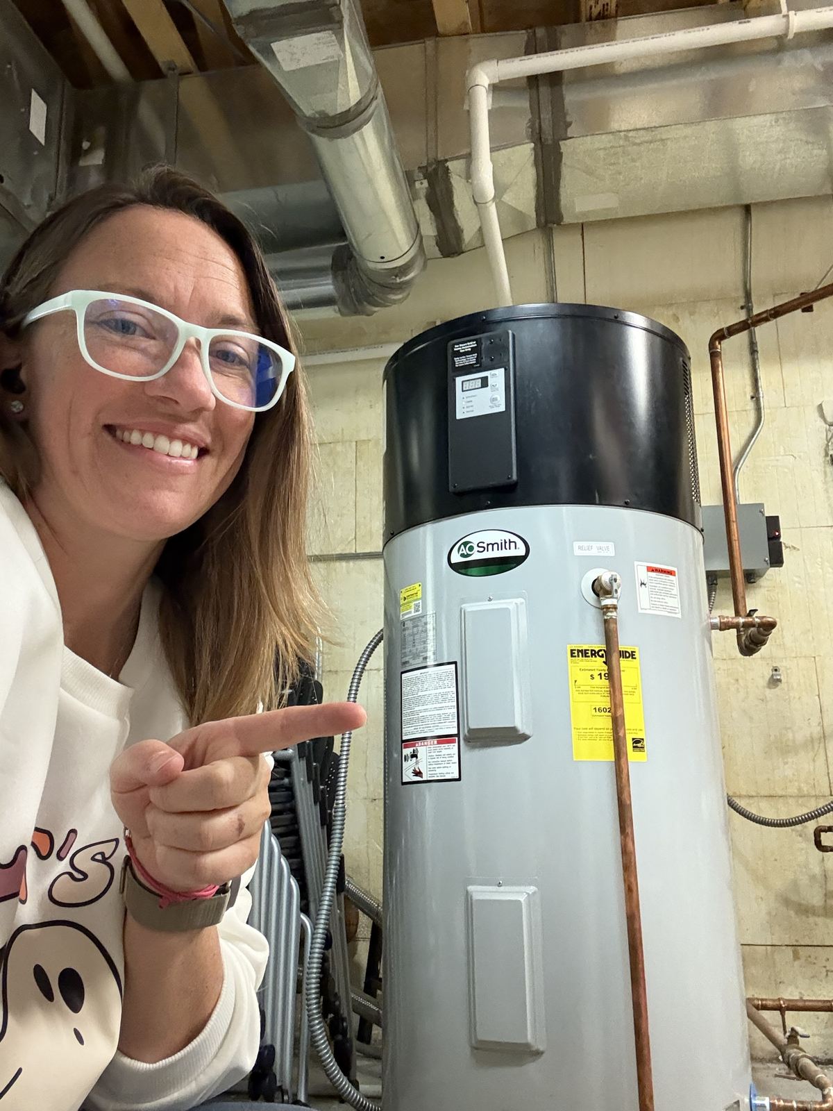 Pointing at a heat pump water heater on vacation
